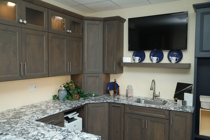 Dark Kitchen Cabinetry And Granite Countertop